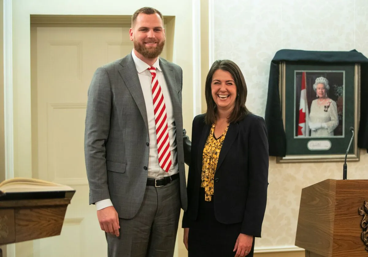 Joseph Schow stands with Alberta Premier Danielle Smith after being sworn into cabinet as House Leader in Edmonton on Oct. 24, 2022. (Jason Franson/The Canadian Press)