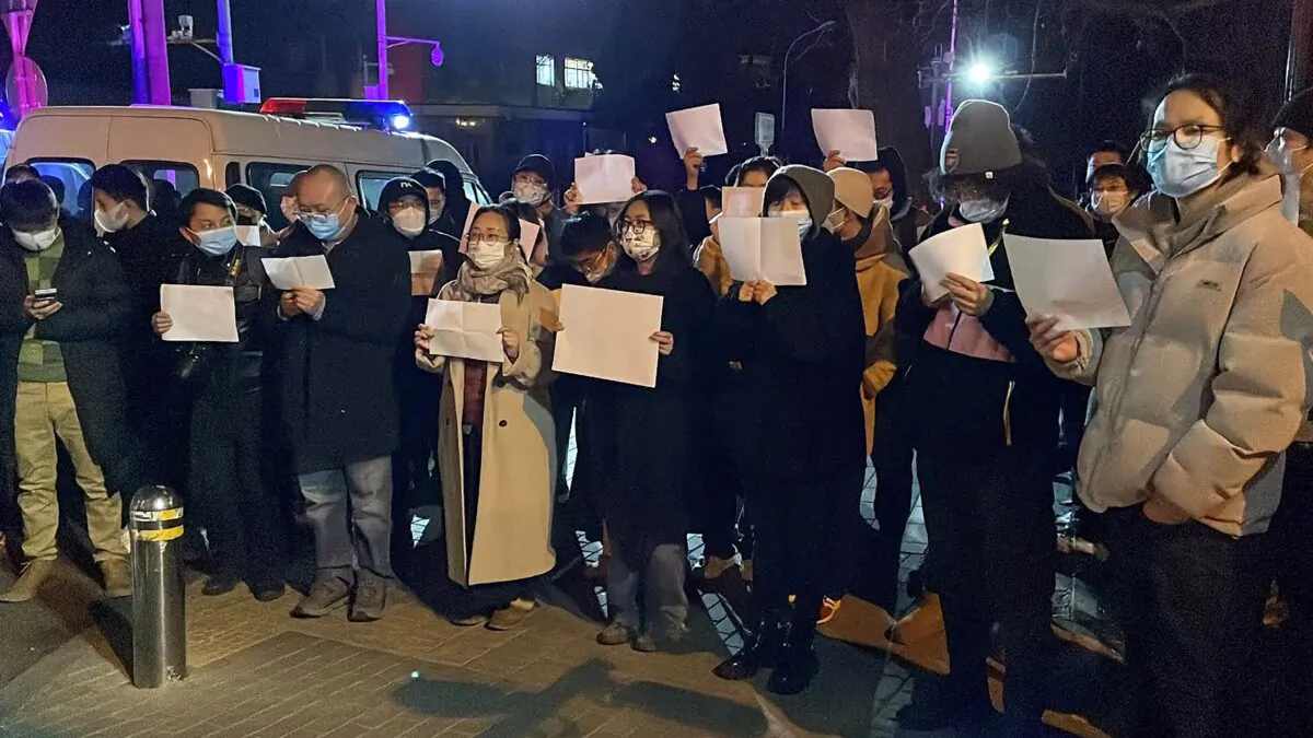 Protesters gather along a street during a rally for the victims of a deadly fire as well as a protest against China's harsh COVID-19 restrictions in Beijing on Nov. 28, 2022. (Michael Zhang / AFP via Getty Images)