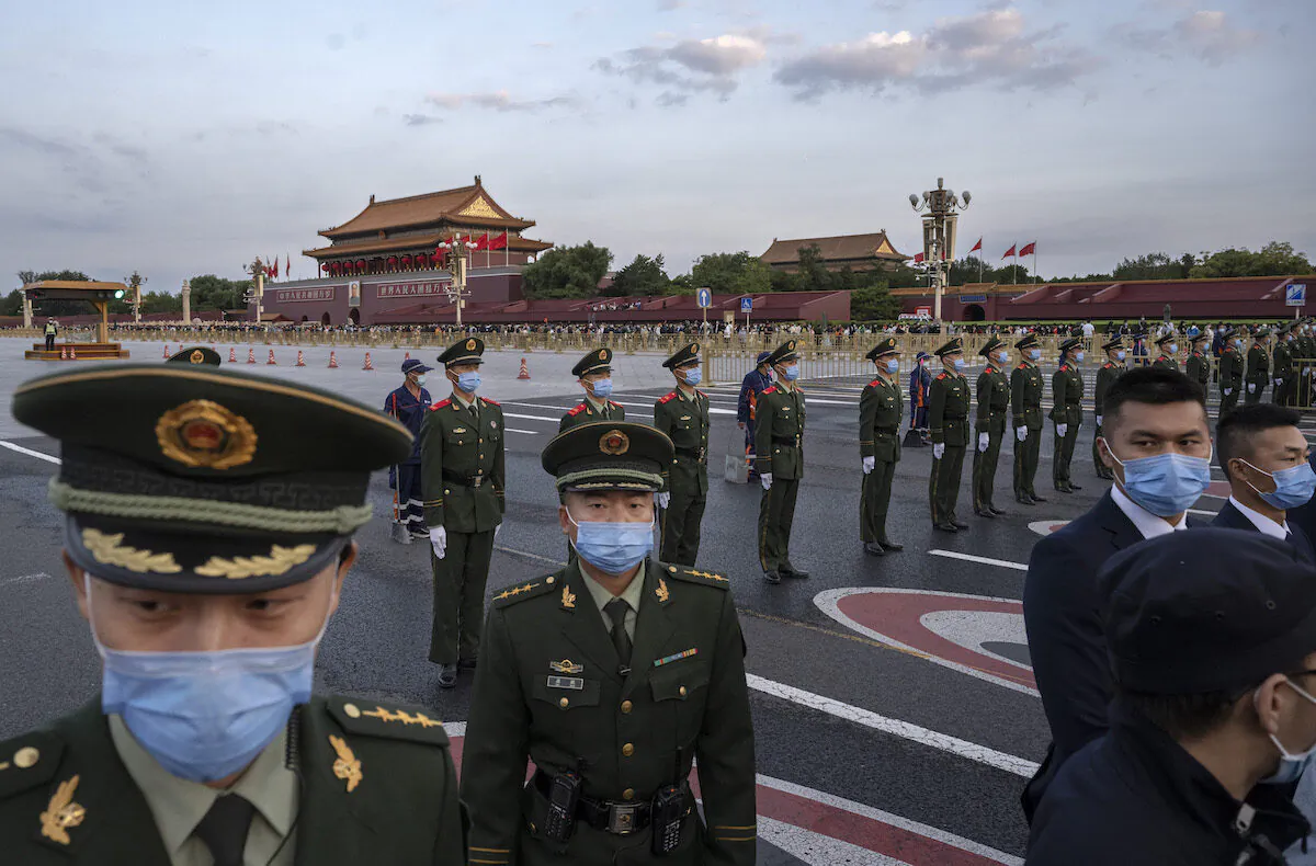 Police officers and security perform crowd control after an official flag raising ceremony next to Tiananmen Square and the Forbidden City in Beijing on Oct. 1, 2021. (Kevin Frayer/Getty Images)