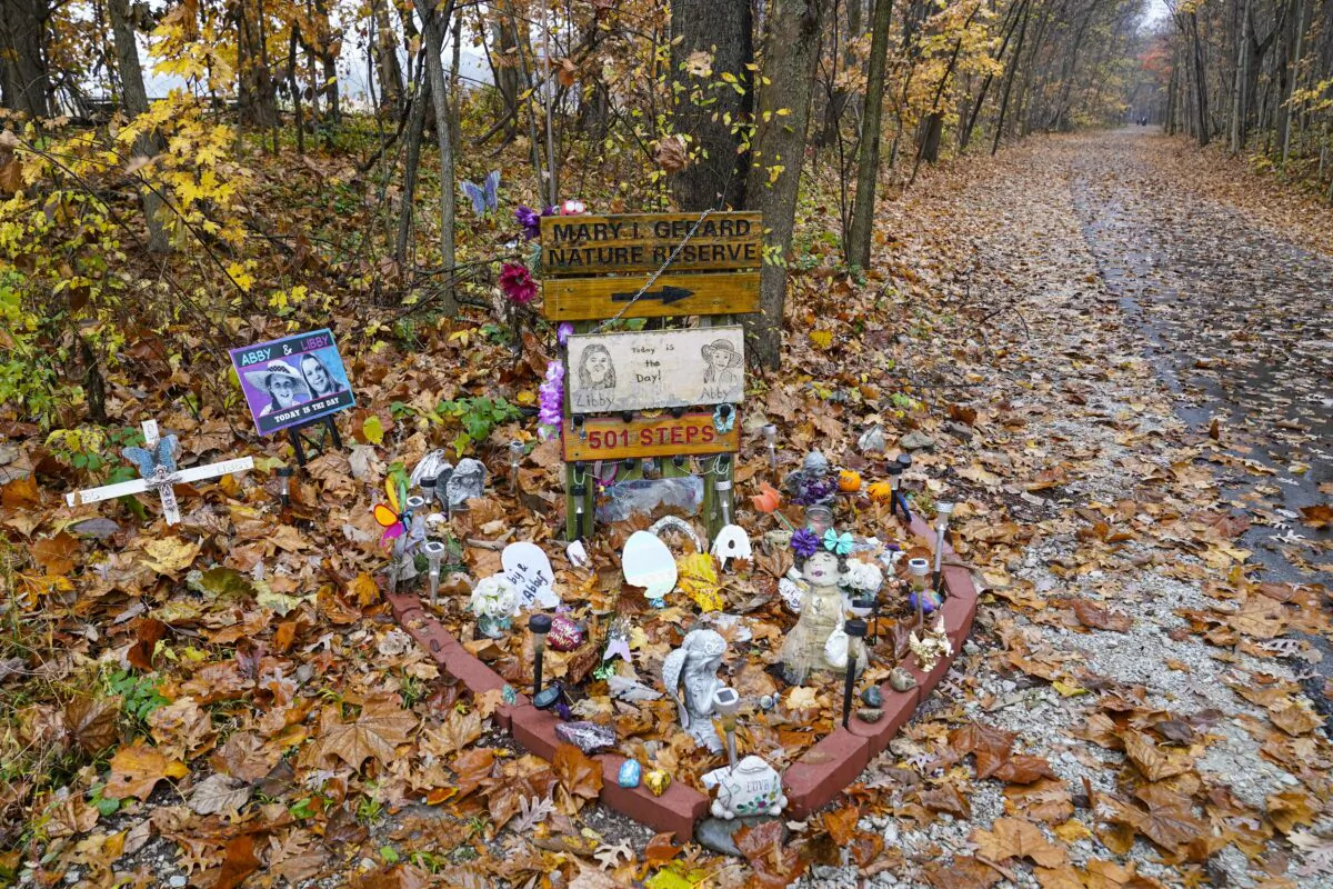 A makeshift memorial to Liberty German and Abigail Williams near where they were last seen and where the bodies were discovered along the Monon Trail leading to the Monon High Bridge Trail in Delphi, Ind., on Oct. 31, 2022. (Michael Conroy/AP Photo)