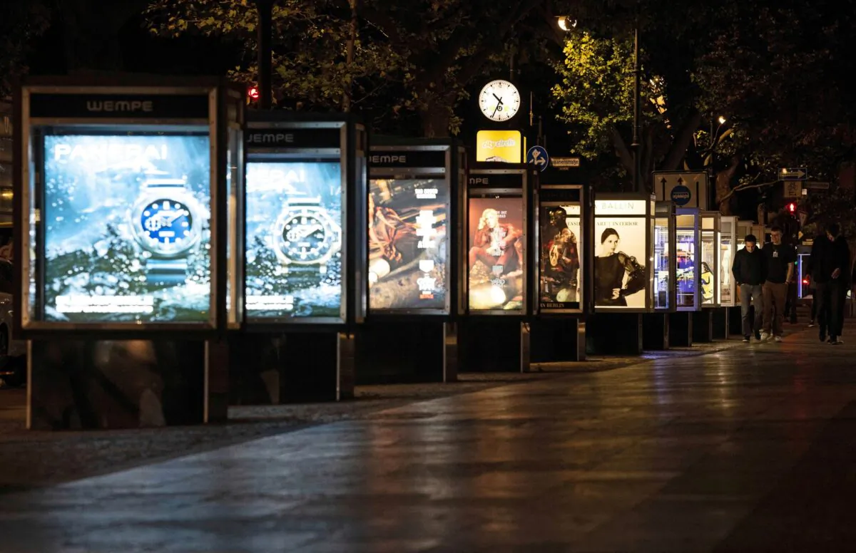 Shop advertisement is illuminated at Kurfuerstendamm shopping street in Berlin on Sept. 1, 2022. (Lisi Niesner/Reuters)