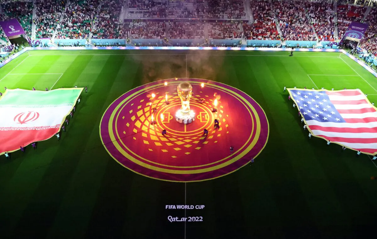 A giant FIFA World Cup trophy replica and fireworks on the pitch alongside Iran and United States flags before the match between Iran and the United States at Al Thumama Stadium, Doha, Qatar, on Nov. 29, 2022. (Fabrizio Bensch/Reuters)