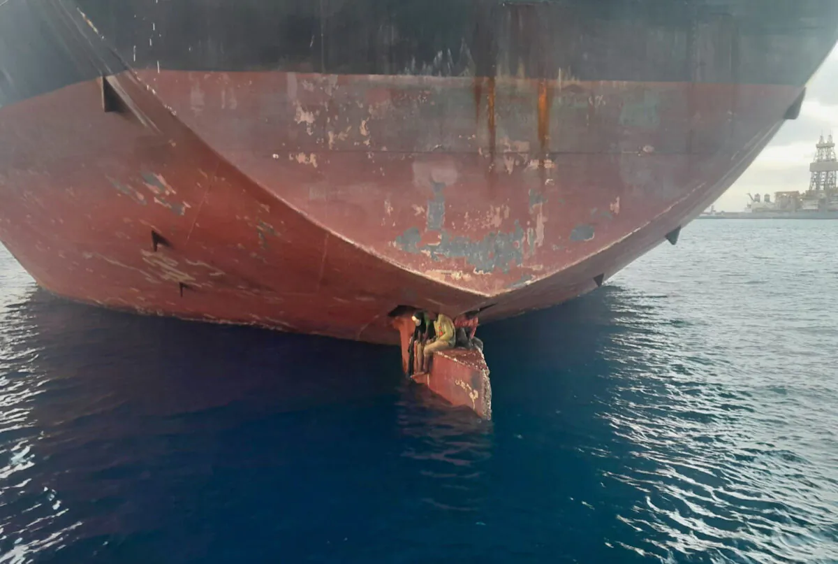 Three men on an oil tanker anchored in the port of the Canary Islands, Spain, on Nov. 29, 2022. (Salvamento Maritimo via AP)