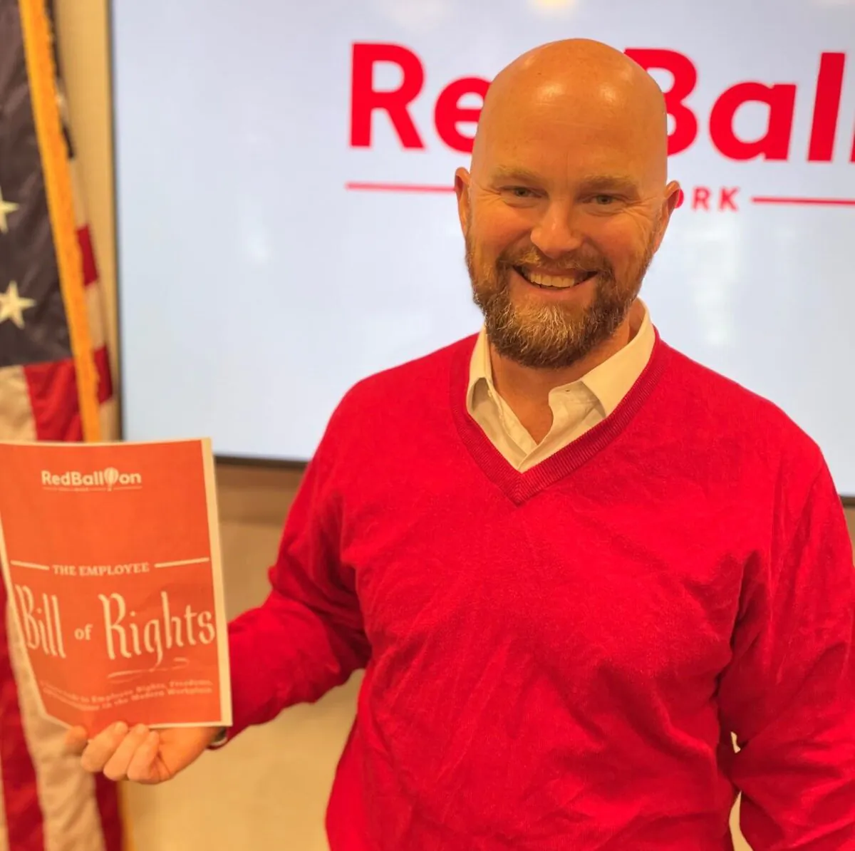 Red Balloon CEO, Andrew Crapuchettes, with the Employee Bill of Rights And Responsibilities. (Courtesy of Red Balloon)
