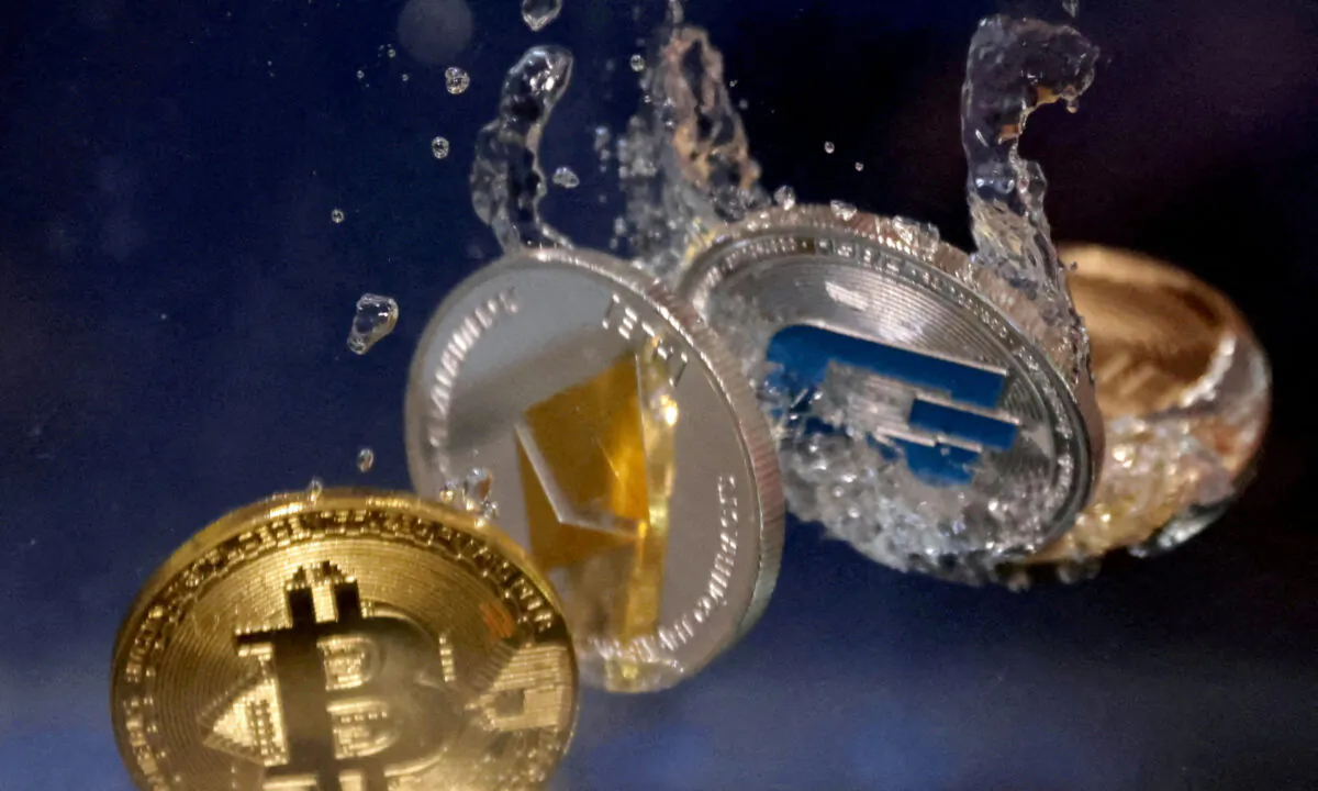 Representations of cryptocurrencies plunge into water in an illustration taken on May 23, 2022. (Dado Ruvic/Illustration/Reuters)