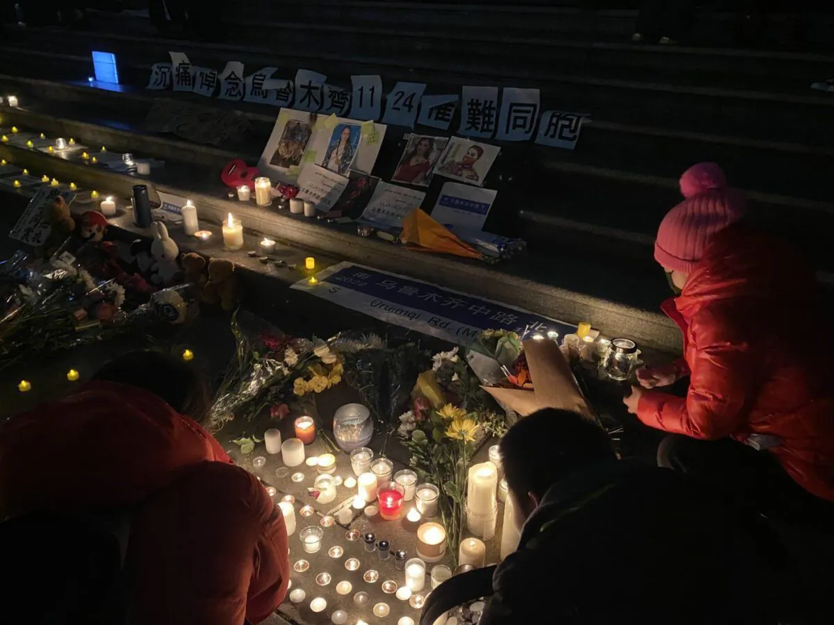 People light candles in front of the Vancouver Art Gallery on Nov. 27, 2022, at a rally in sympathy with protests that are sweeping across China. (The Canadian Press/Nono Shen)