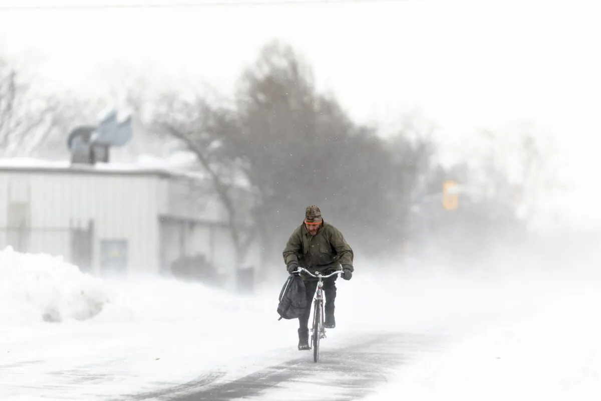 A man rides his bike down the street in Fort Erie, Ont., Nov. 19, 2022. (The Canadian Press/Nick Iwanyshyn)