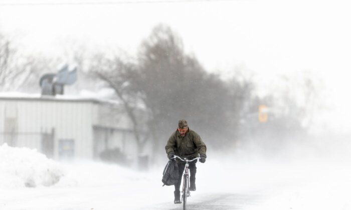 A man rides his bike down the street in Fort Erie, Ont., Nov. 19, 2022. (The Canadian Press/Nick Iwanyshyn)
