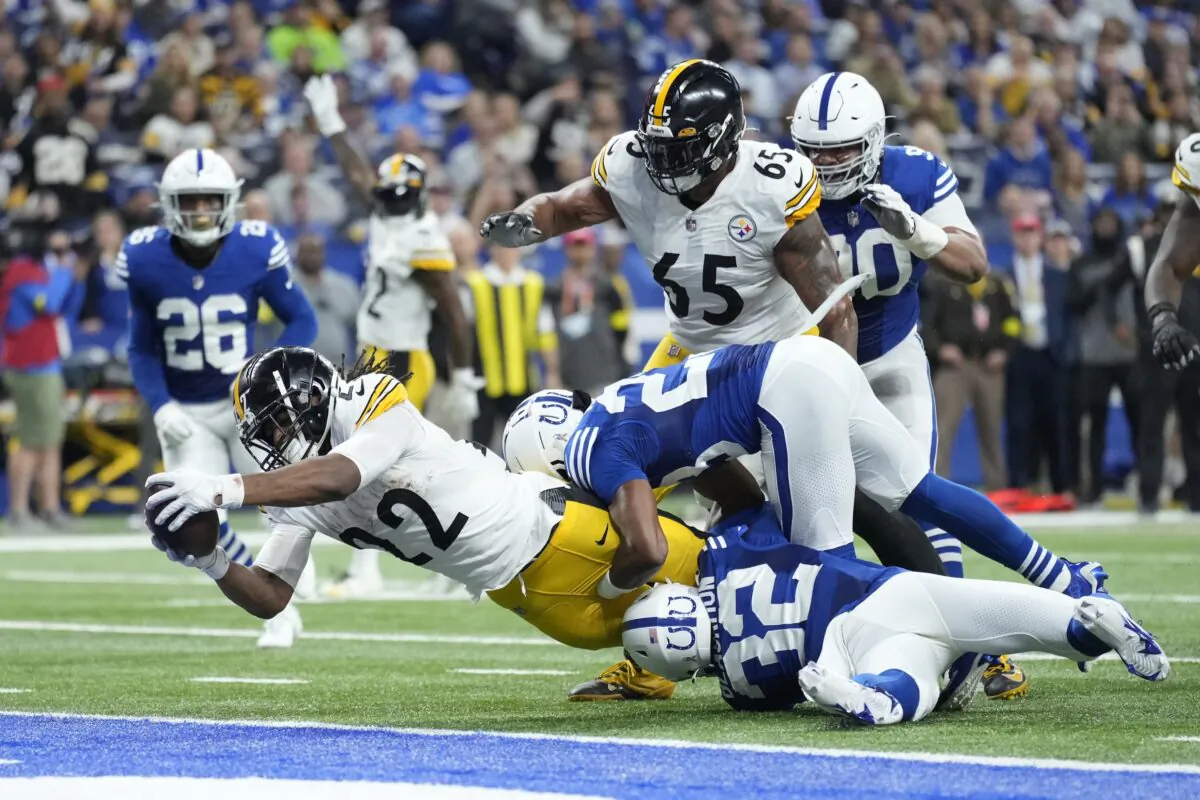 Pittsburgh Steelers' Najee Harris (22) dives  for a touchdown against the Colts' Julian Blackmon (32) and Kenny Moore II (23) during the first half of a game in Indianapolis on Nov. 28, 2022. (AJ Mast/AP Photo)