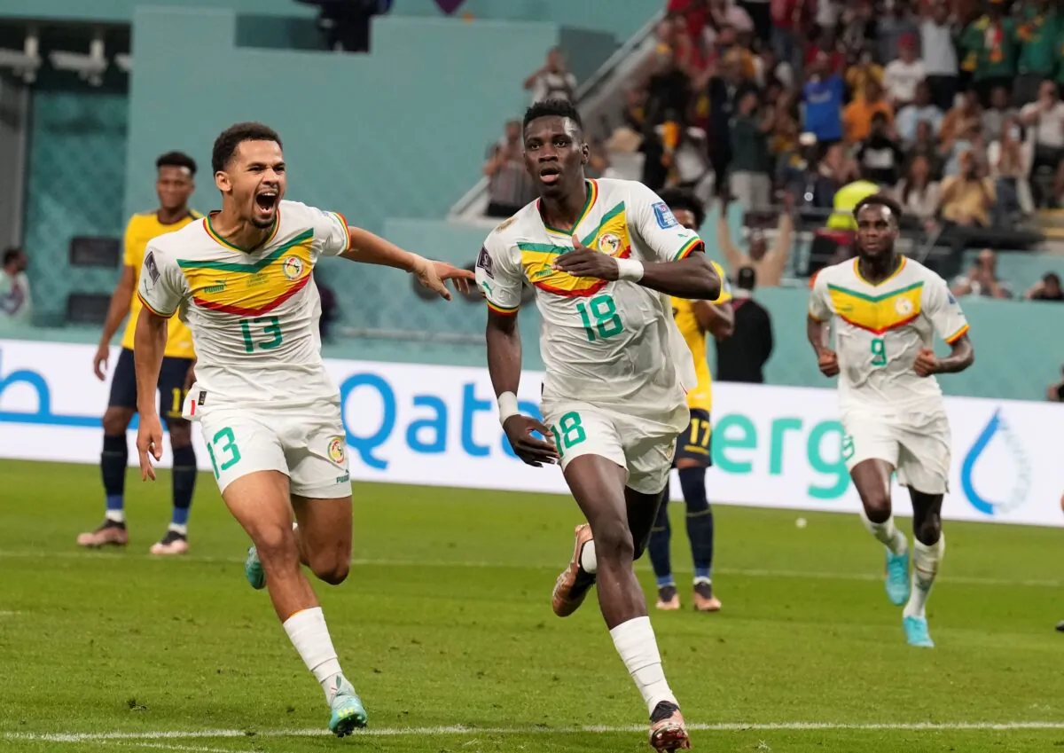 Senegal's Ismaila Sarr (R) celebrates with teammates after scoring a penalty, the opening goal of his team, during the World Cup group A soccer match between Ecuador and Senegal, at the Khalifa International Stadium in Doha, Qatar, on Nov. 29, 2022. (Natacha Pisarenko/AP Photo)