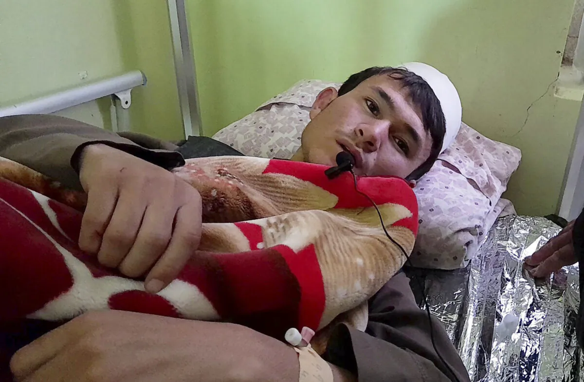 A wounded man receives treatment at a hospital after a deadly bomb blast at a religious school in Aybak, the capital of the Samangan province in northern Afghanistan, on Nov. 30, 2022. (Saifullah Karimi/AP Photo)