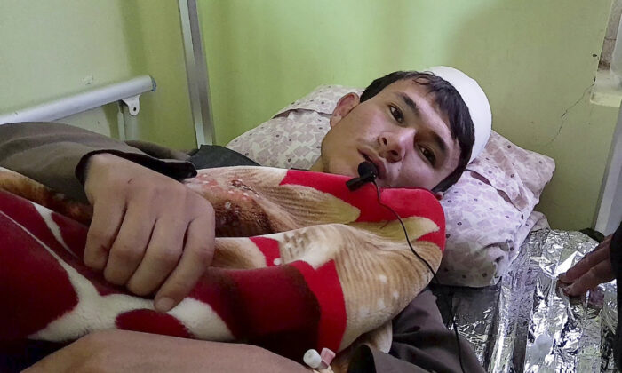 An injured man is treated in hospital after an explosion at a religious school in Aibak, capital of Samangan province in northern Afghanistan, November 30, 2022.  (Saifullah Karimi/AP Photo)