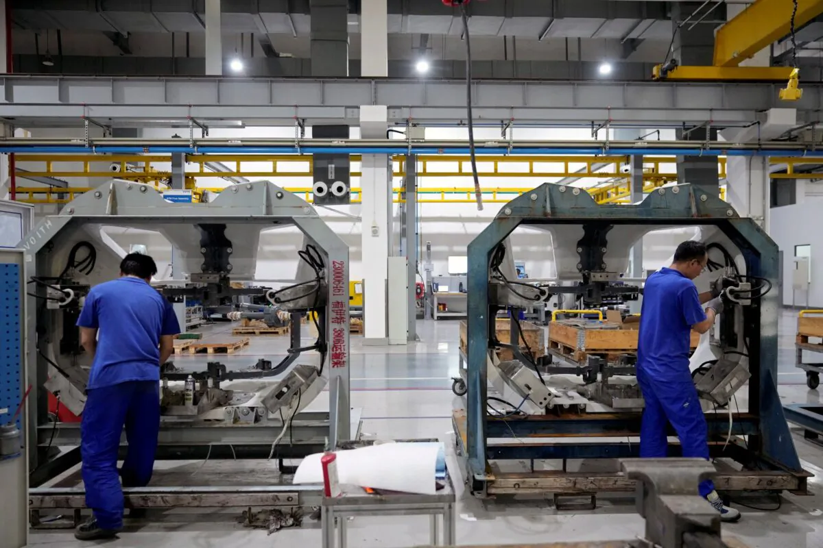 Employees work on the production line of high speed train components in Shanghai on July 21, 2022. (Aly Song/Reuters)