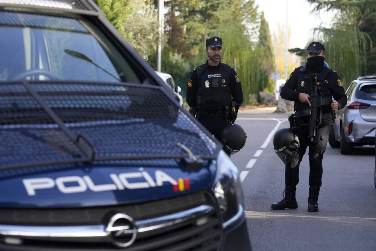 Police officers stand guard as they cordon off the area next to the Ukrainian embassy in Madrid on Nov. 30, 2022. (Paul White/AP Photo)