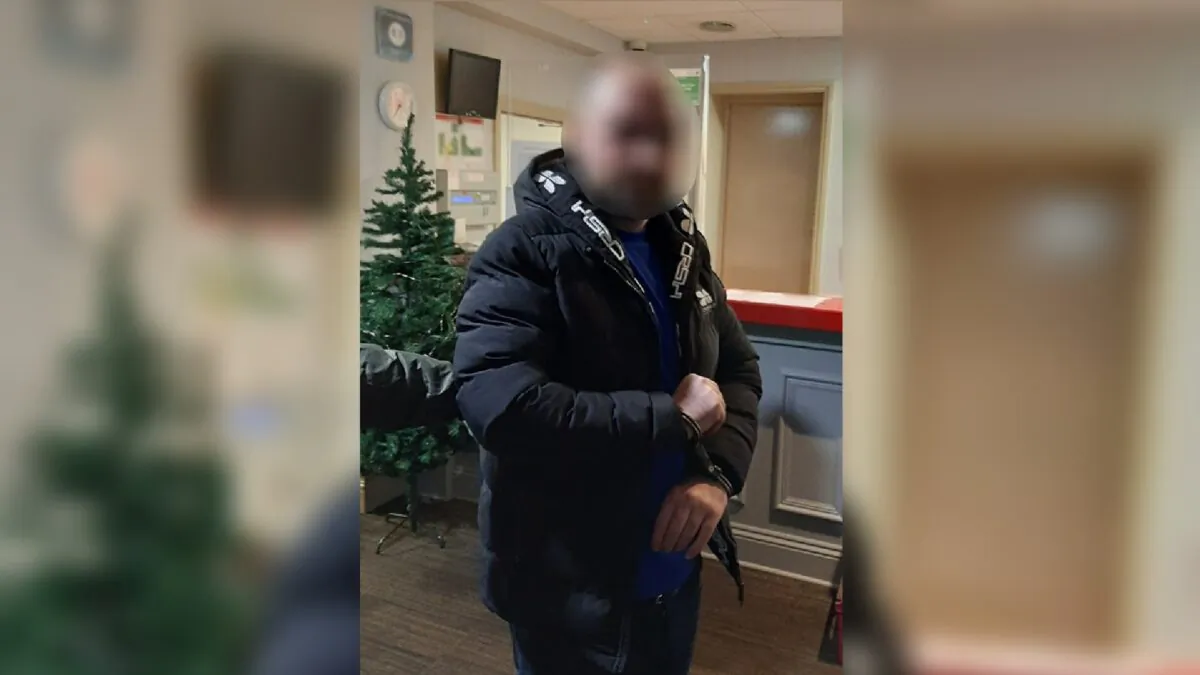 Harem Ahmed Abwbaker in handcuffs at a police station in Gloucestershire, England, after his arrest on Nov. 29, 2022. (National Crime Agency)
