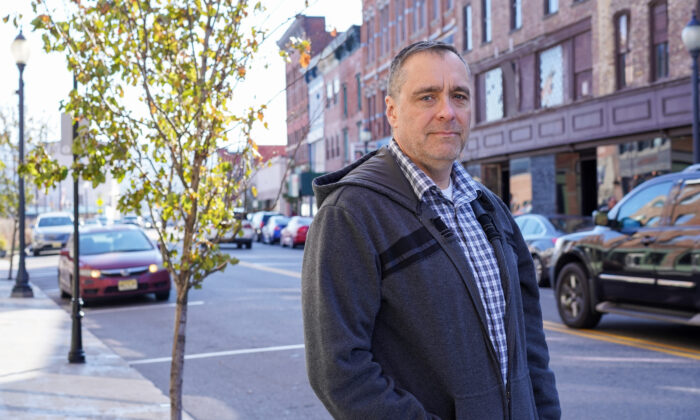 Michael Worden stands in downtown Port Jervis, N.Y., on Nov. 23, 2022. (Cara Ding/The Epoch Times)