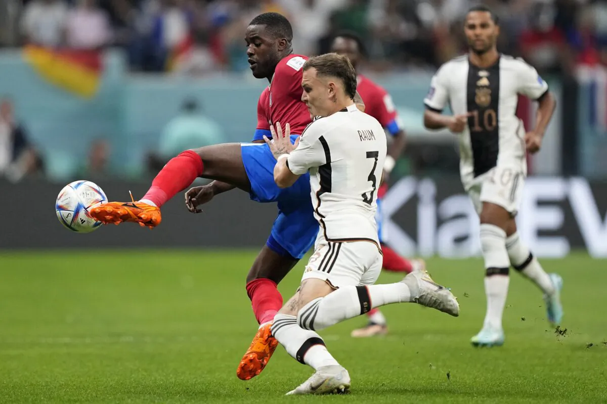 Costa Rica's Joel Campbell (L) and Germany's David Raum challenge for the ball during the World Cup group E soccer match between Costa Rica and Germany at the Al Bayt Stadium in Al Khor, Qatar, on Dec. 1, 2022. (Martin Meissner/AP Photo)