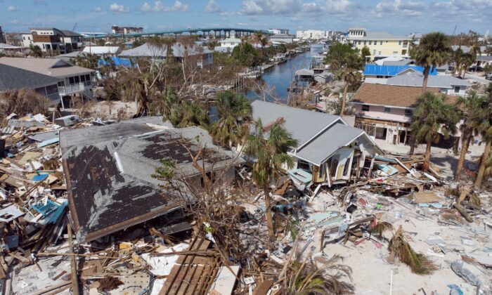 Remains of destroyed houses are seen astir   1  period  aft  Hurricane Ian landfall, successful  Fort Myers Beach, Fla., connected  Oct. 26, 2022. (Marco Bello/Reuters)