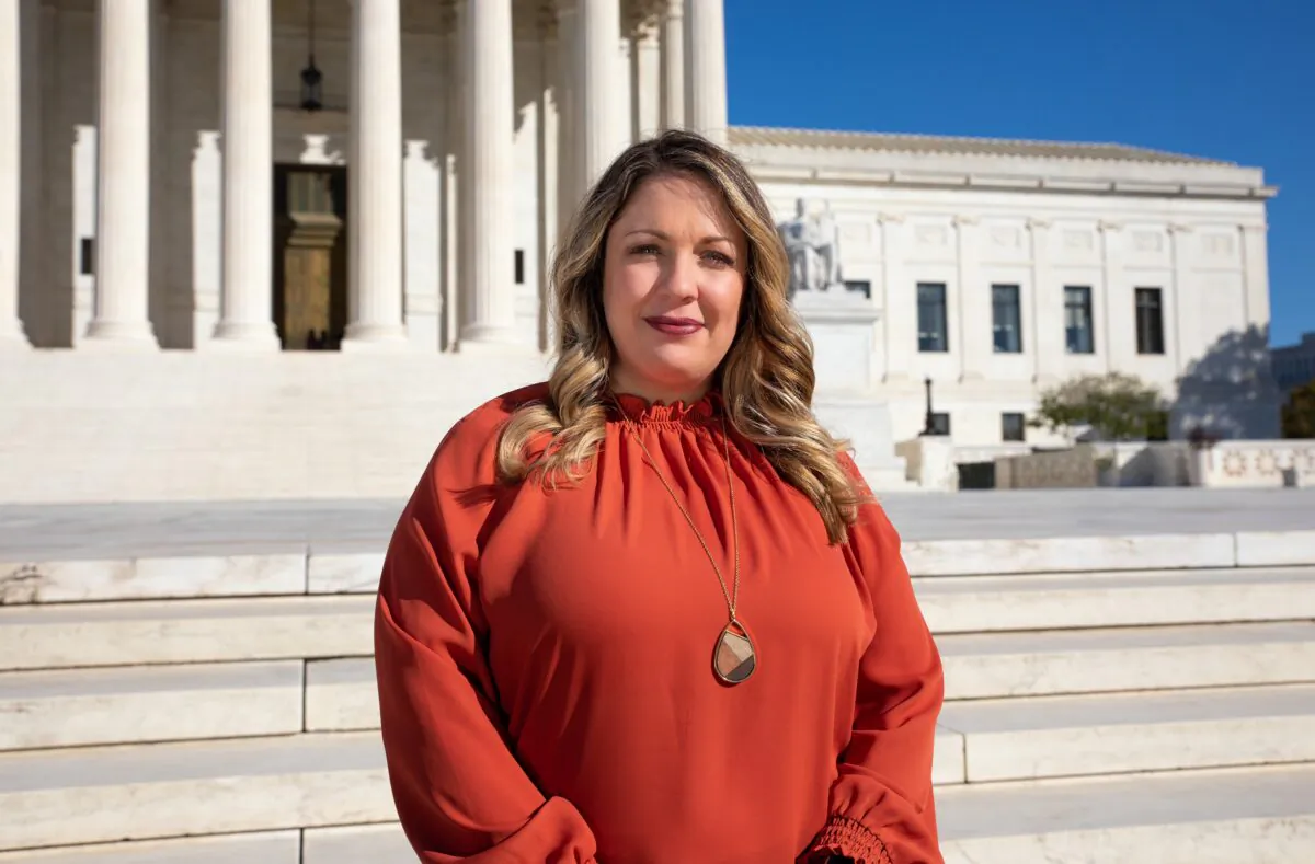 Christian website designer Lorie Smith, owner of 303 Creative, poses in an undated photo outside the Supreme Court. (Photo courtesy Alliance Defending Freedom)