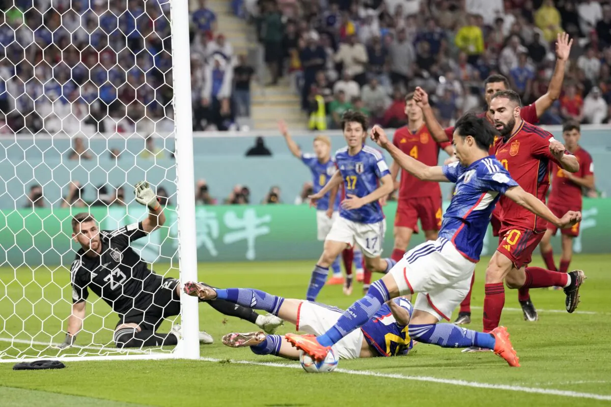 Japan's Kaoru Mitoma passes the ball to teammate Ao Tanaka who score the second goal against Spain during a World Cup group E soccer match at the Khalifa International Stadium in Doha, Qatar, on Dec. 1, 2022. (Eugene Hoshiko/AP Photo)