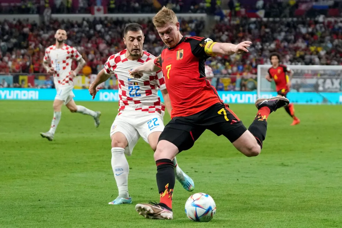 Belgium's Kevin De Bruyne (R) and Croatia's Josip Juranovic (L) fight for the ball during the World Cup group F soccer match between Croatia and Belgium at the Ahmad Bin Ali Stadium in Al Rayyan, Qatar, on Dec. 1, 2022. (Thanassis Stavrakis/AP Photo)