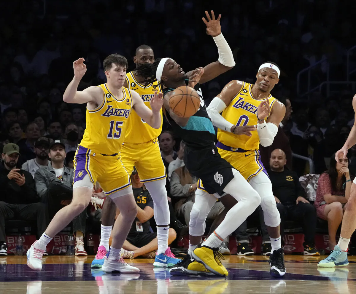 Jerami Grant (9) of the Portland Trail Blazers is fouled by Russell Westbrook (0) of the Los Angeles Lakers with Austin Reaves (15) defending during the second half in Los Angeles, on Nov. 30, 2022. (Kevork Djansezian/Getty Images)