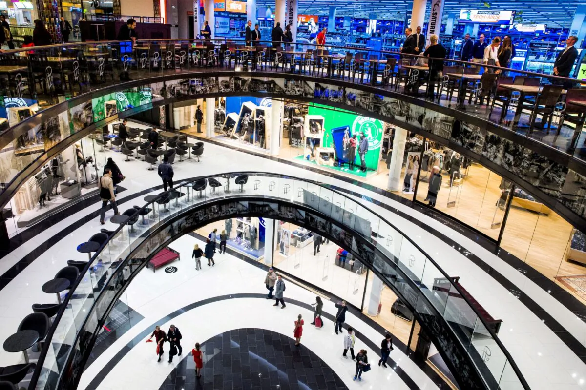 People walk through the Mall of Berlin shopping center during its opening night in Berlin, Germany, on Sept. 24, 2014. (Thomas Peter/Reuters)