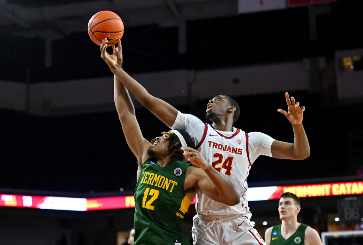 Perry Smith Jr. (12) of the Vermont Catamounts and Joshua Morgan (24) of the USC Trojans reach for a rebound in the first half at Galen Center in Los Angeles, on Nov. 15, 2022. (Jayne Kamin-Oncea/Getty Images)