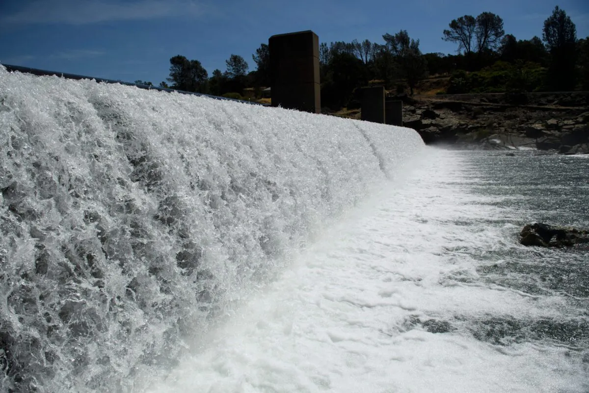 Water flows over the Feather River Fish Barrier dam as it diverts Chinook Salmon up a fish ladder to the California Department of Fish and Wildlife Feather River Hatchery below the Lake Oroville dam in Oroville, Calif., on May 27, 2021. (Patrick T. Fallon/AFP via Getty Images)