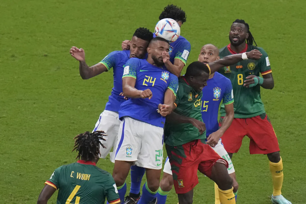 A group of players jumps for a header during the World Cup group G soccer match between Cameroon and Brazil, at the Lusail Stadium in Lusail, Qatar, on Dec. 2, 2022. (Alessandra Tarantino/AP Photo)