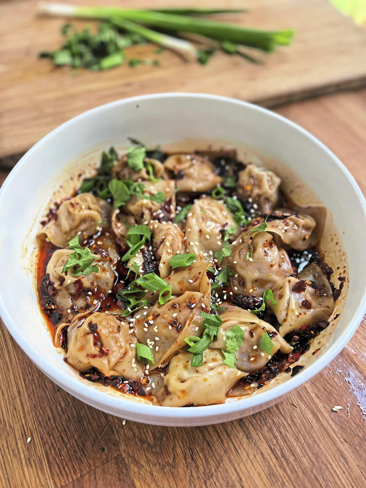 Bathed in fiery sauce enlivened with garlic and Sichuan peppercorn, these pork-stuffed wontons are a spicy bowl of perfection. (Gretchen McKay/Pittsburgh Post-Gazette/TNS)