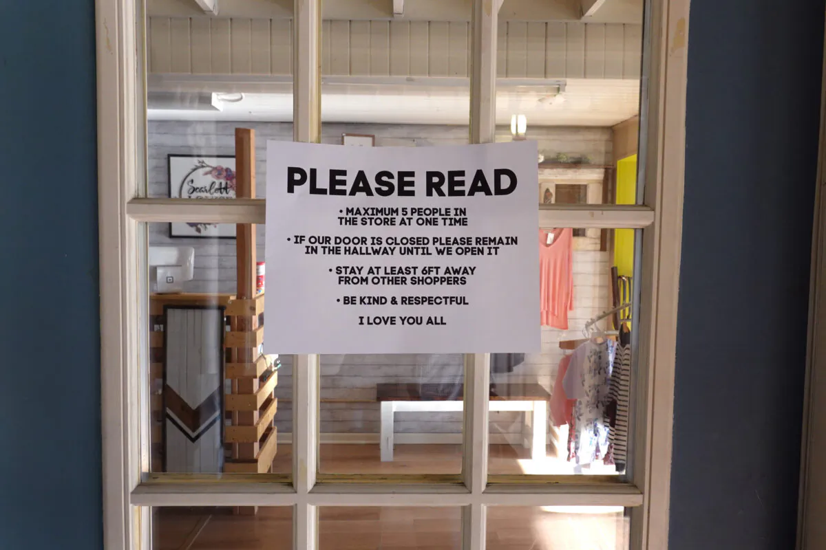 A sign on the front door of a business spells out new rules for customers in Elkhorn, Wis., on May 15, 2020. (Scott Olson/Getty Images)