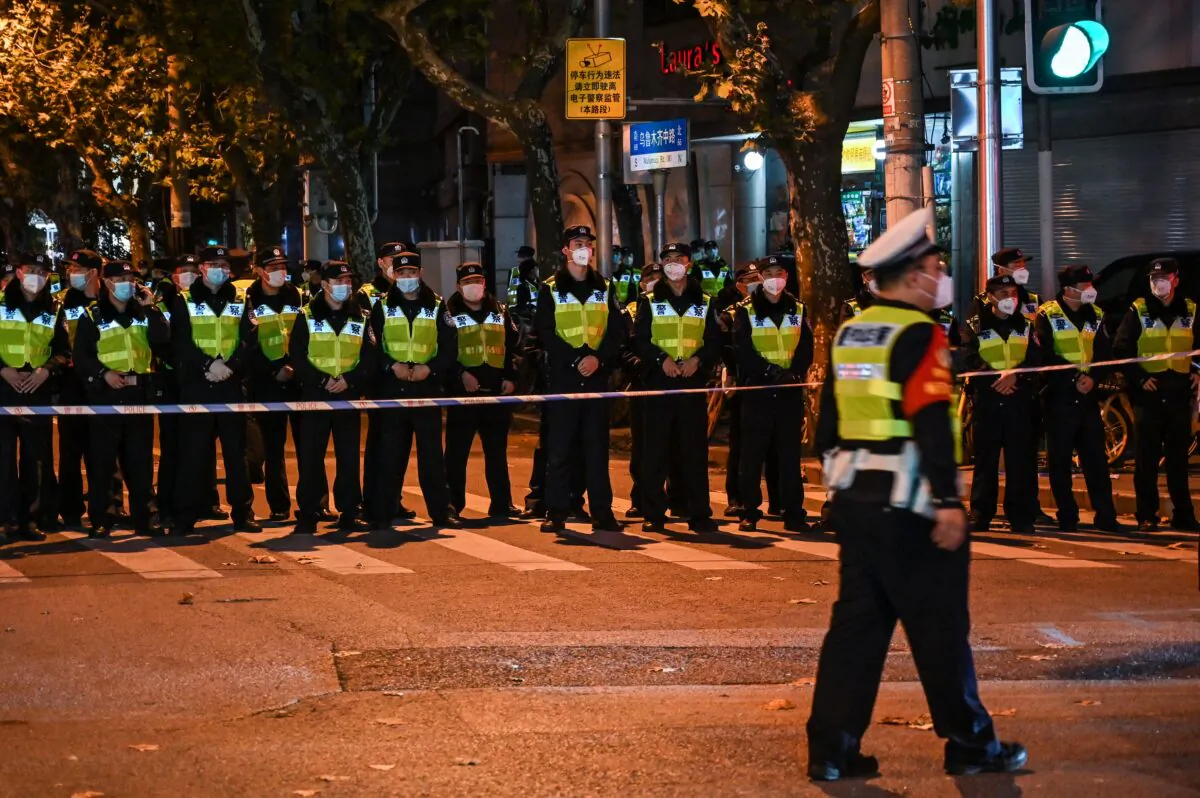 Police officers block Wulumuqi street, named for Urumqi, in Shanghai, China, on Nov. 27, 2022. (Hector Retamal/AFP via Getty Images)
