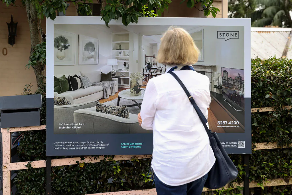 People look at a signboard of a property for sale in Sydney, Australia, on May 5, 2022. (Brendon Thorne/Getty Images)