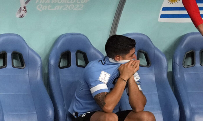Uruguay's Luis Suarez sits on the bench during the World Cup group H soccer match between Ghana and Uruguay, at the Al Janoub Stadium in Al Wakrah, Qatar, on Dec. 2, 2022. (Themba Hadebe/AP Photo)
