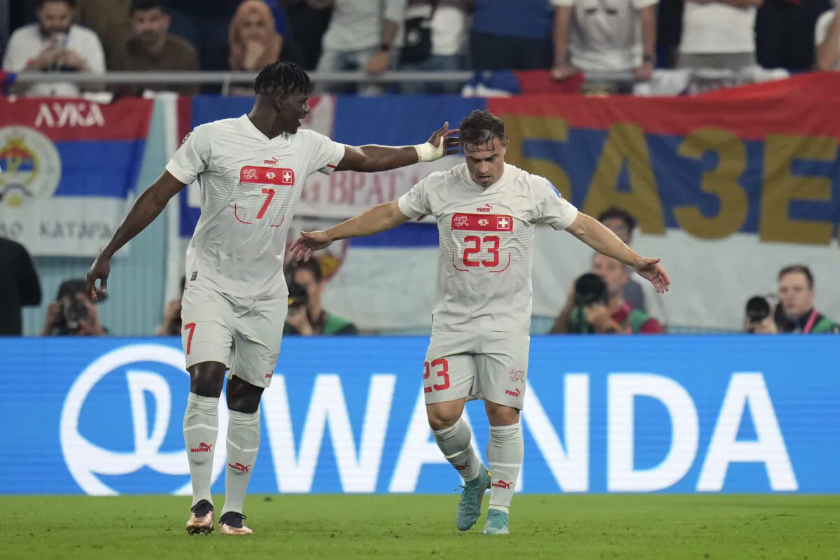 Switzerland's Xherdan Shaqiri (R) celebrates with teammate Breel Embolo after scoring his side's first goal during the World Cup group G soccer match between Serbia and Switzerland, in Doha, Qatar, on Dec. 2, 2022. (Ricardo Mazalan/AP Photo)
