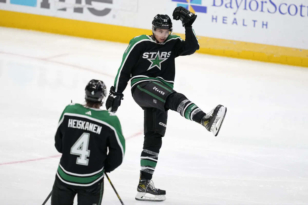 Dallas Stars left wing Jason Robertson celebrates his third goal of the night against the Anaheim Ducks, as defenseman Miro Heiskanen (4) watches during the third period of an NHL hockey game on Dec. 1, 2022. (Tony Gutierrez/AP Photo)
