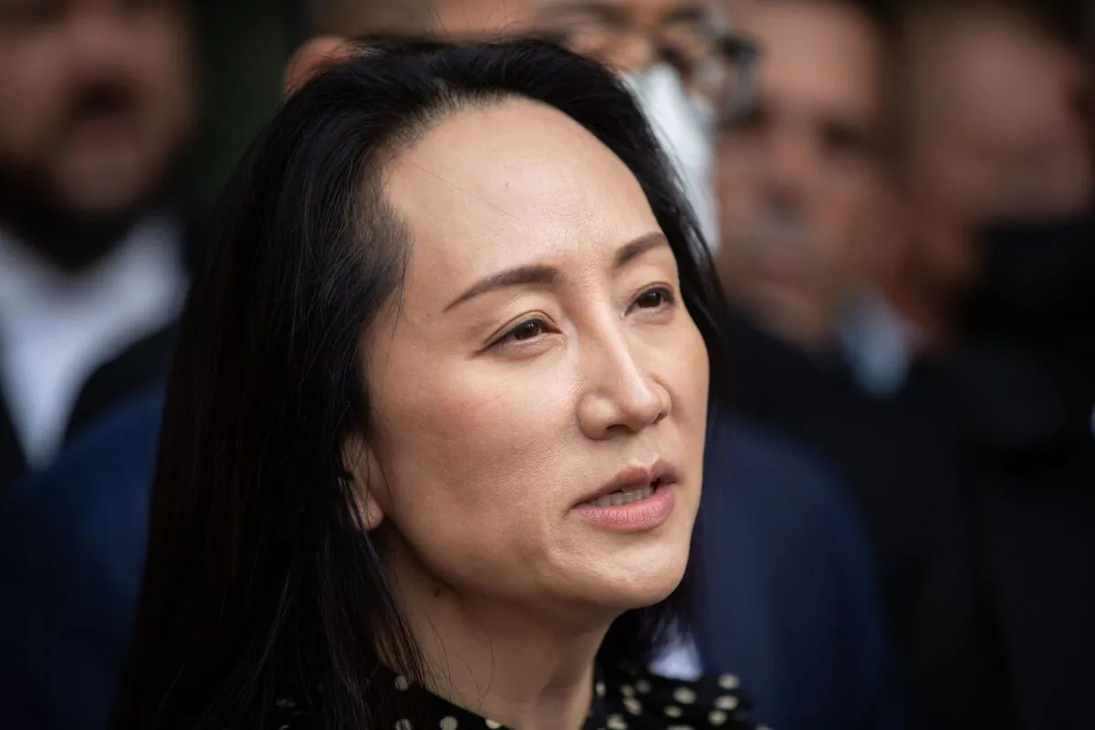 Meng Wanzhou, chief financial officer of Huawei, reads a statement outside B.C. Supreme Court, in Vancouver, B.C., Sept. 24, 2021. (The Canadian Press/Darryl Dyck)
