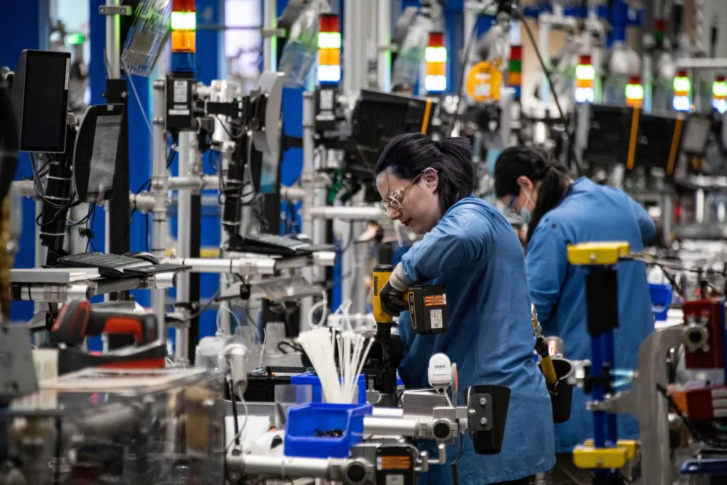 Employees build and test robots at Amazon's BOS27 Robotics Innovation Hub in Westborough, Mass., on Nov. 10, 2022. (Joseph Prezioso/AFP via Getty Images)