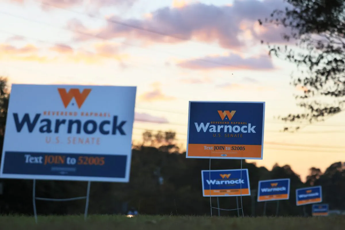 Democratic Senate candidate Sen. Raphael Warnock (D-Ga.) signs are seen at a Get Out the Vote rally in the parking lot of Abundant Life Full Gospel in Columbus, Ga., on Nov. 7, 2022. (Michael M. Santiago/Getty Images)