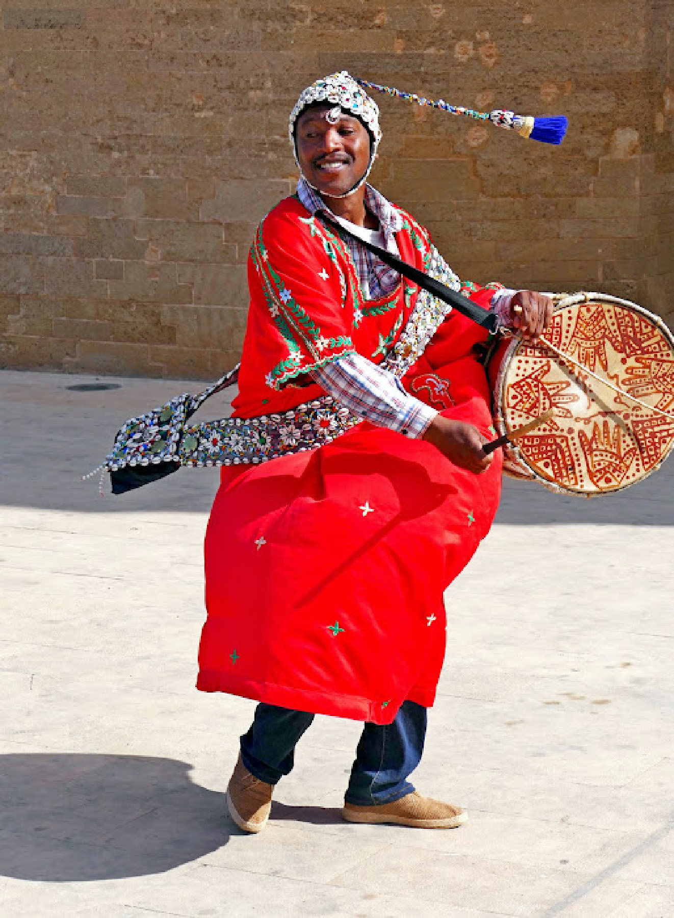 A gnawa musician plays and sings outside the Kasbah des Oudaias in Rabat, Morocco.