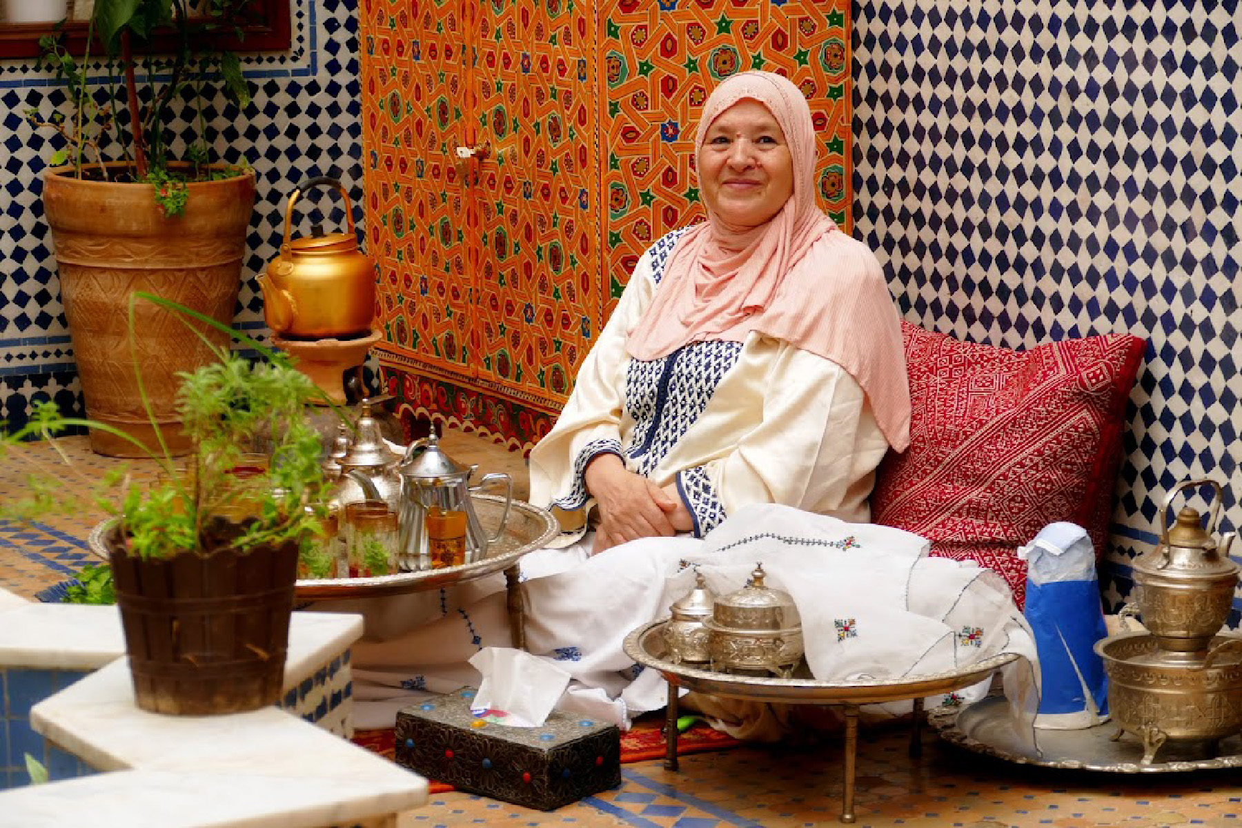 A woman serves mint tea to guests at her home in Fes, Morocco.