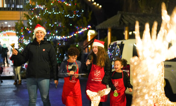 Salvation Army Port Jervis Pastor Valentina Agudelo and a group of young volunteers sing during the Christmas Market at New Century in Deerpark, N.Y., on Dec. 3, 2022. (Cara Ding/The Epoch Times)