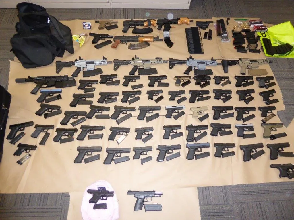 Toronto police announced on December 5, 2022, that they had seized 62 illegal guns as part of an organized crime firearms trafficking bust. (Toronto Police Handout)