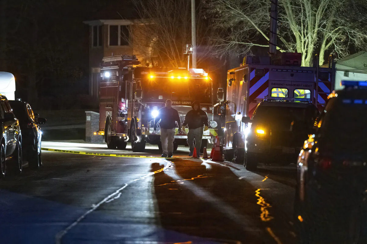 Buffalo Grove Police work the scene where multiple people were found dead inside a home in Buffalo Grove, Ill., on Nov. 30, 2022. (Tyler Pasciak LaRiviere/Chicago Sun-Times via AP)