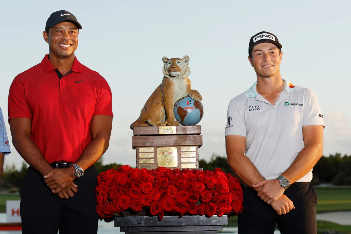 Viktor Hovland of Norway celebrates with the trophy and host Tiger Woods after winning during the final round Hero World Challenge at Albany Golf Course in Nassau, Bahamas, on Dec. 4, 2022. (Mike Ehrmann/Getty Images)