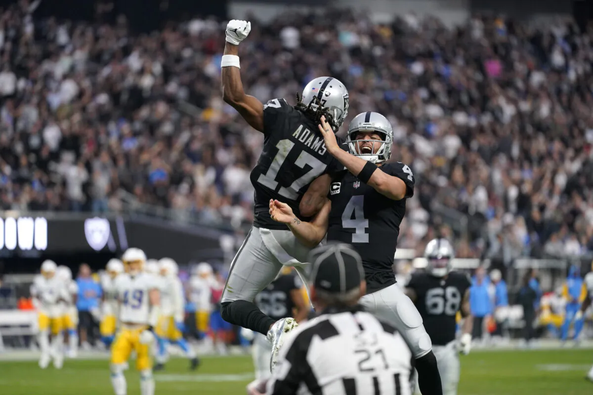 Las Vegas Raiders quarterback Derek Carr (4) and wide receiver Davante Adams (17) celebrate their touchdown during the second half of an NFL football game against the Los Angeles Chargers, in Las Vegas, on Dec. 4, 2022. (Matt York/AP Photo)