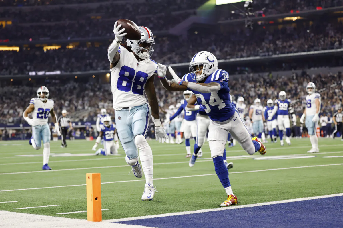 CeeDee Lamb (88) of the Dallas Cowboys scores a touchdown as Isaiah Rodgers (34) of the Indianapolis Colts defends in the first quarter at AT&T Stadium in Arlington, Texas, on Dec. 4, 2022. (Wesley Hitt/Getty Images)
