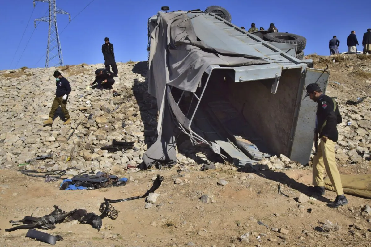 Pakistani security officials inspect a truck carrying police officers damaged by a suicide bombing on the outskirts of Quetta, Pakistan, on Nov. 30, 2022. (Arshad Butt/AP Photo)