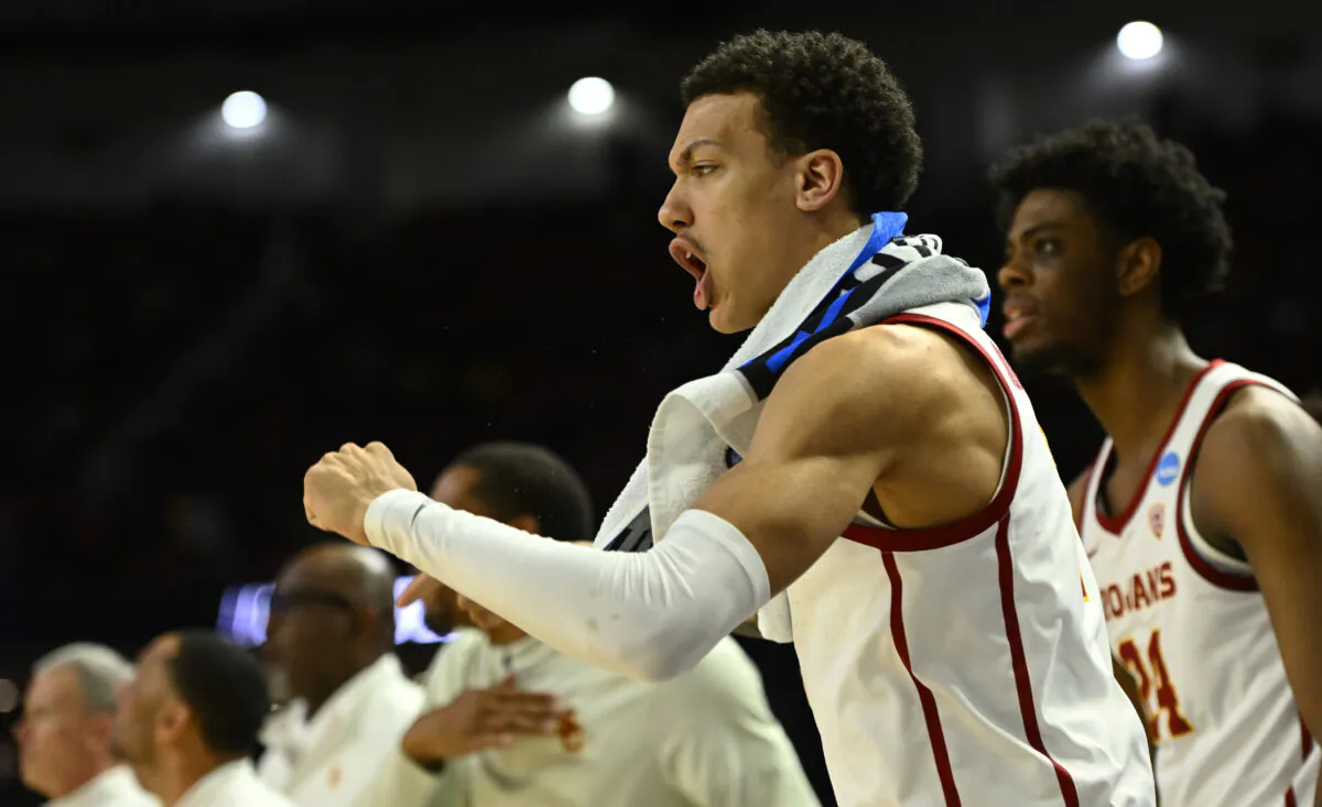 Kobe Johnson (2) of the USC Trojans cheers from the bench against Miami (Fl) Hurricanes during the second half in the first round game of the 2022 NCAA Men's Basketball Tournament at Bon Secours Wellness Arena in Greenville, S. C., on March 18, 2022. (Eakin Howard/Getty Images)
